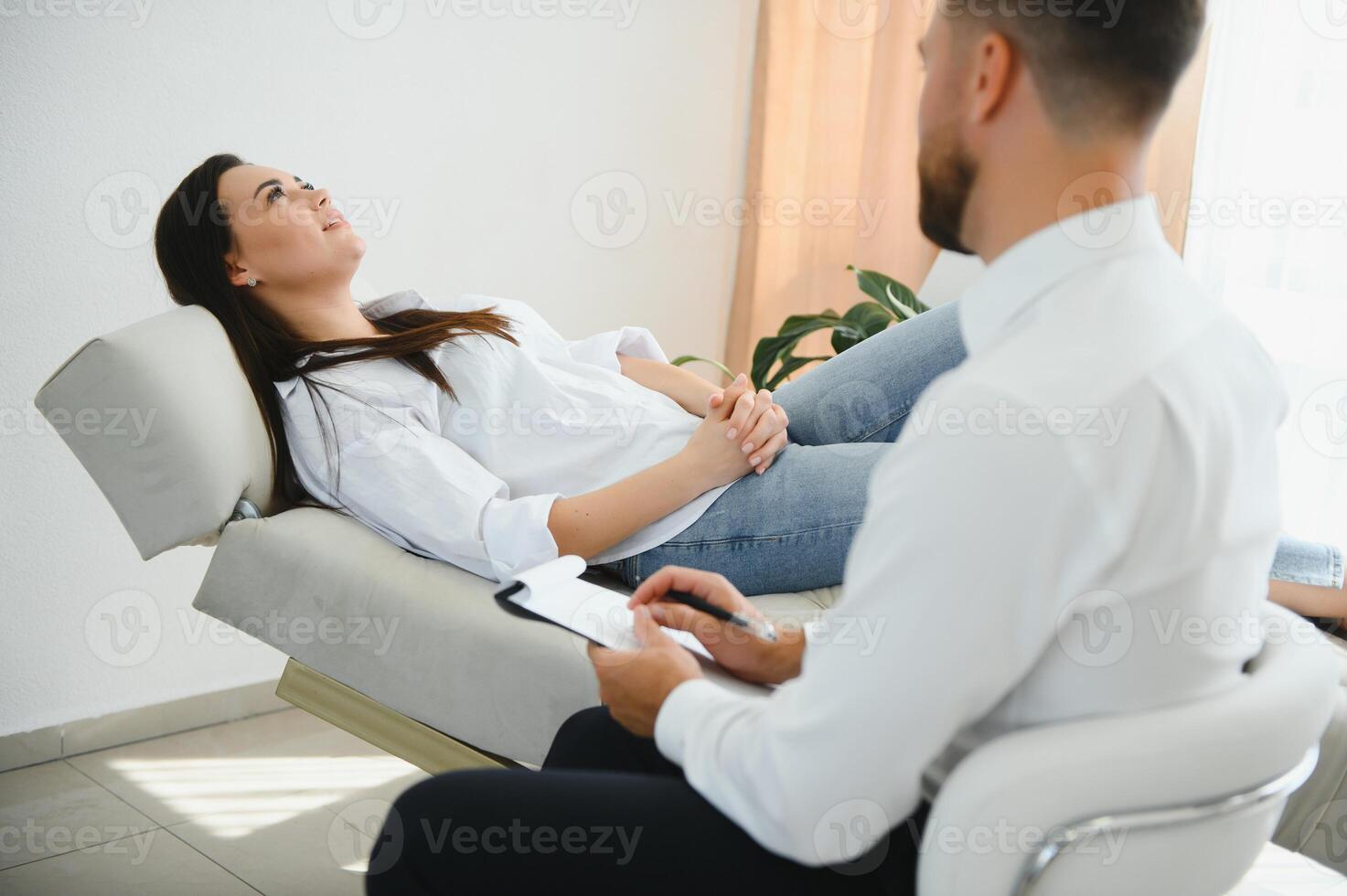 Young woman visiting therapist counselor. Girl feeling depressed, unhappy and hopeless, needs assistance. Serious disease, unwilling pregnancy, abort or death of loved one, addiction to drugs concept photo
