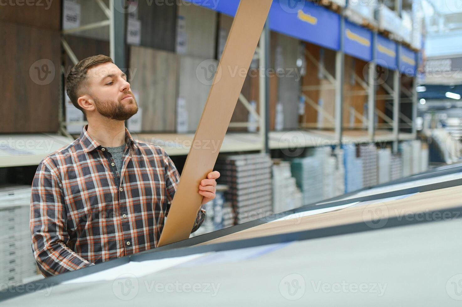 Man choosing flooring in hardware store photo