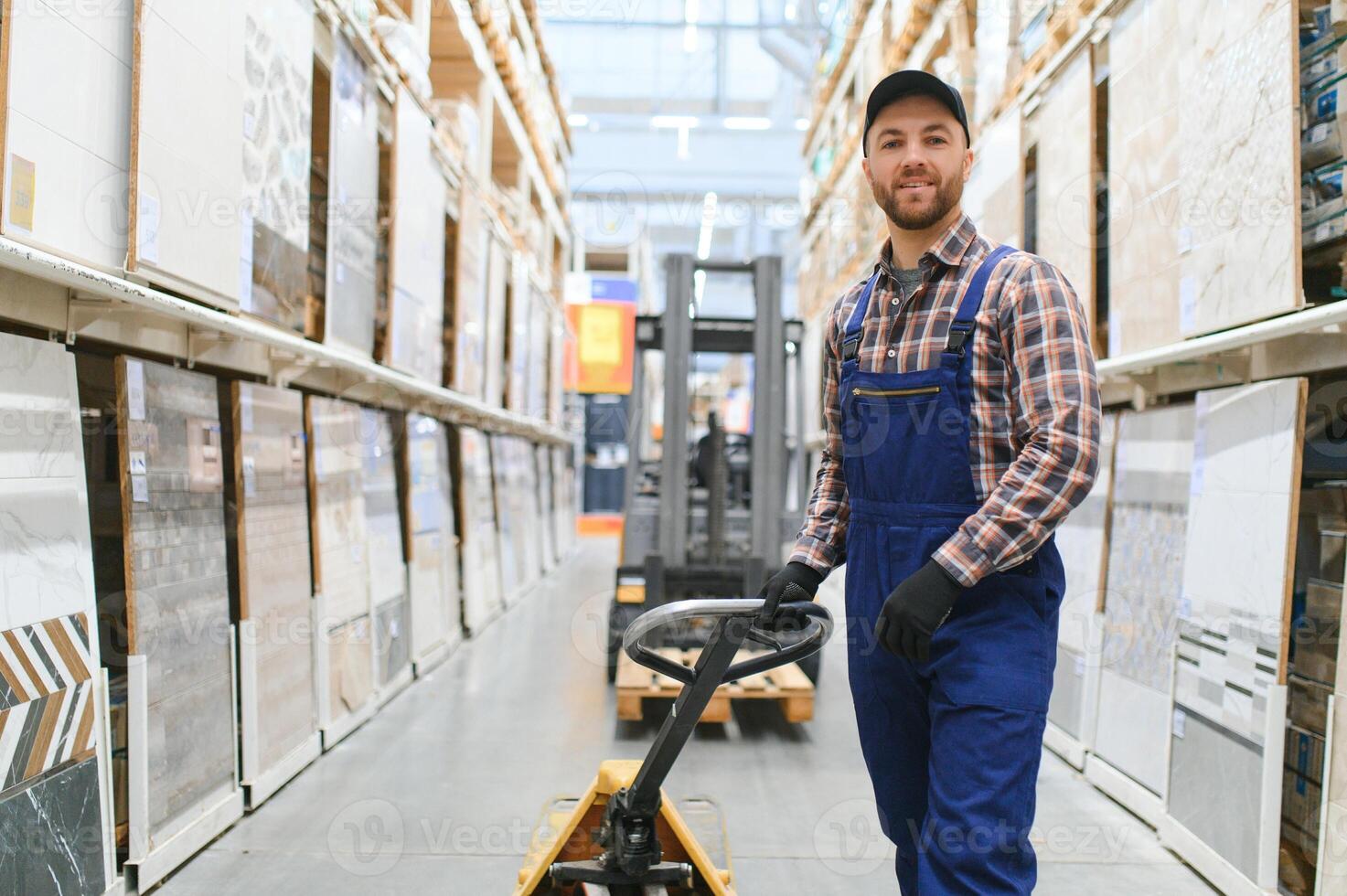 a worker in a hardware store stands in a warehouse photo