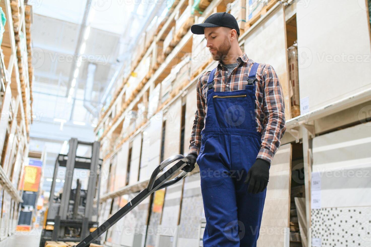 a worker in a hardware store stands in a warehouse photo