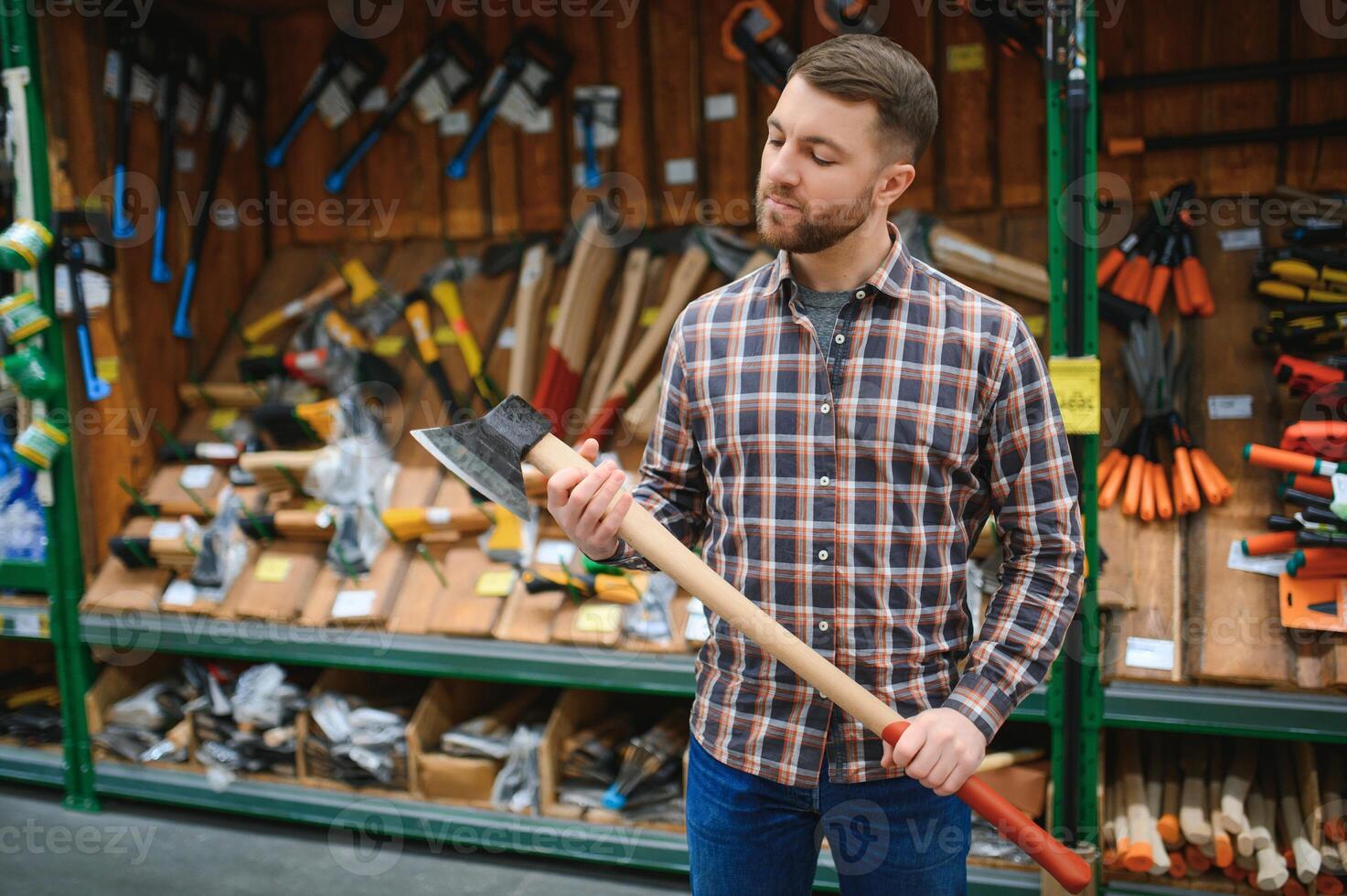happy customer in a hardware store buying a new ax photo