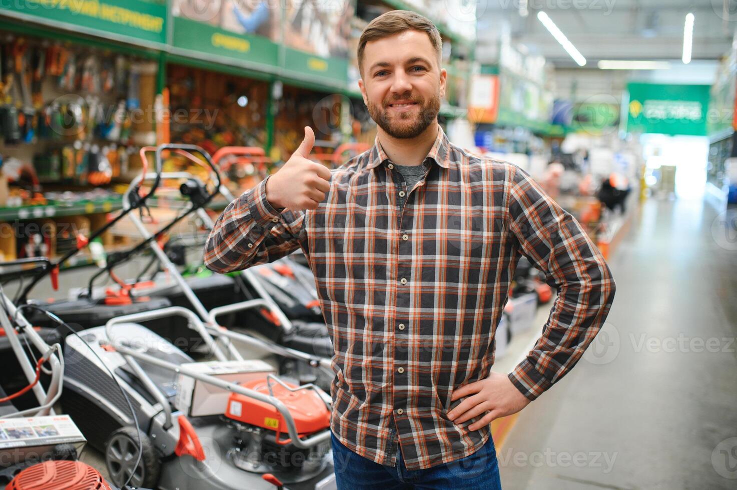 a young man in a gardening equipment store photo