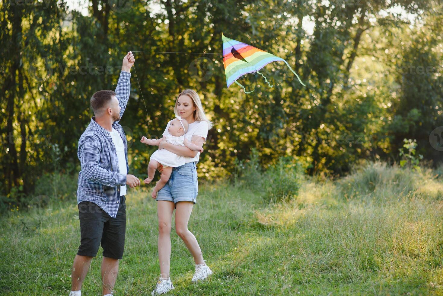 Happy young family spending time together outside in green nature. photo