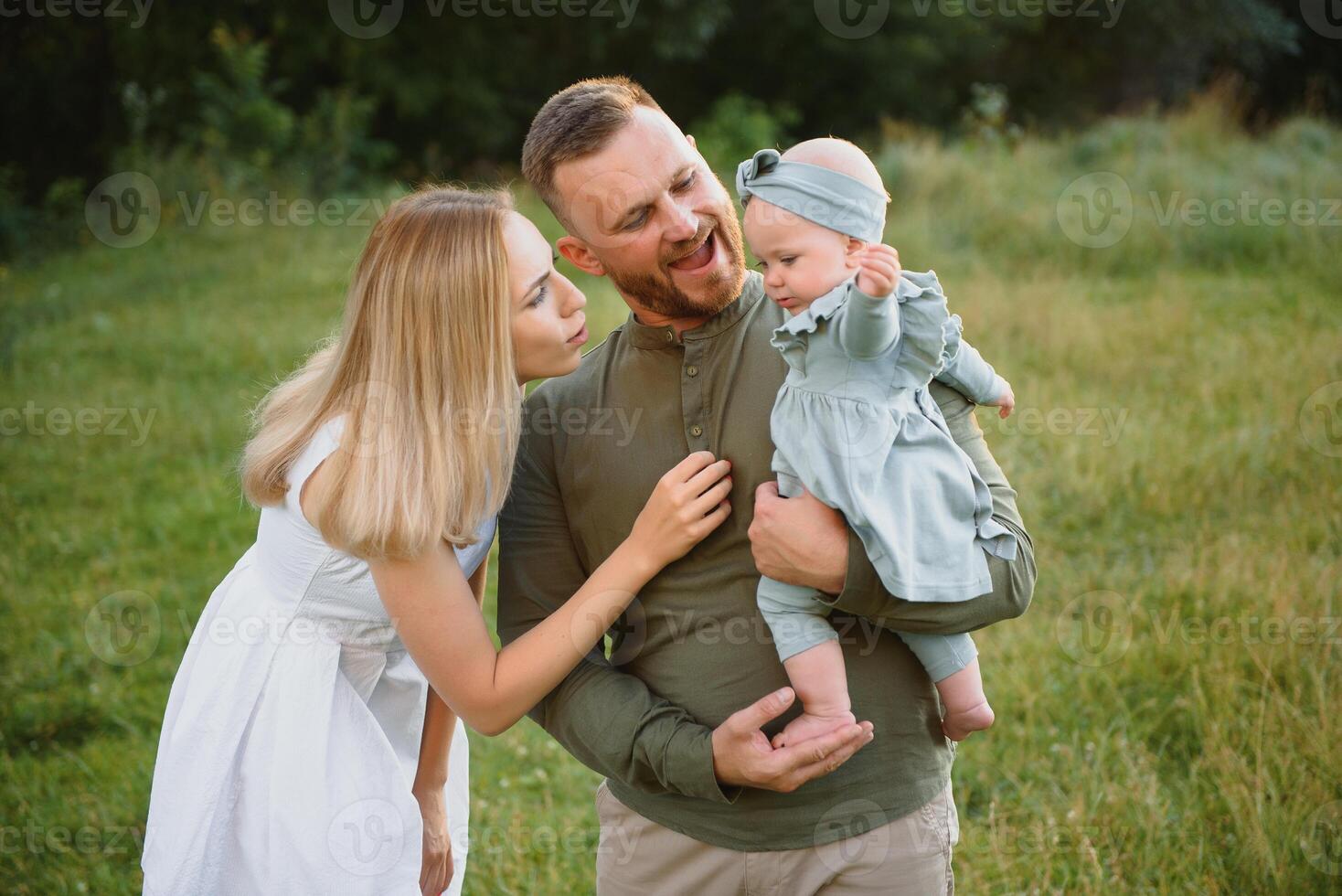 Happy young family spending time together outside in green nature. photo