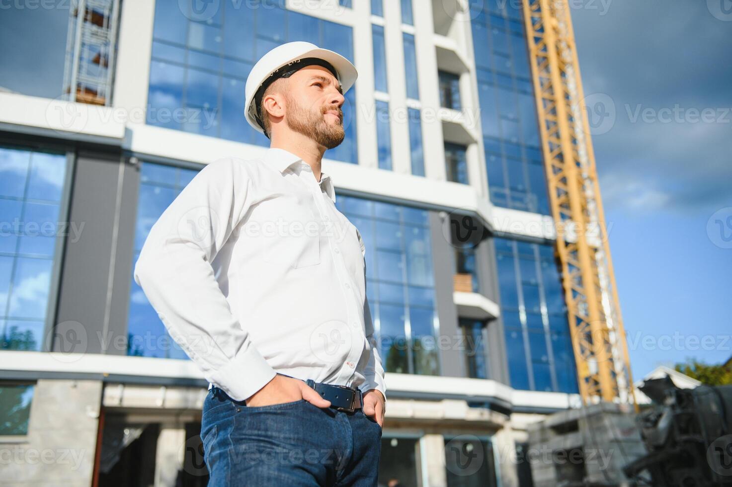 Architect in helmet near new building photo