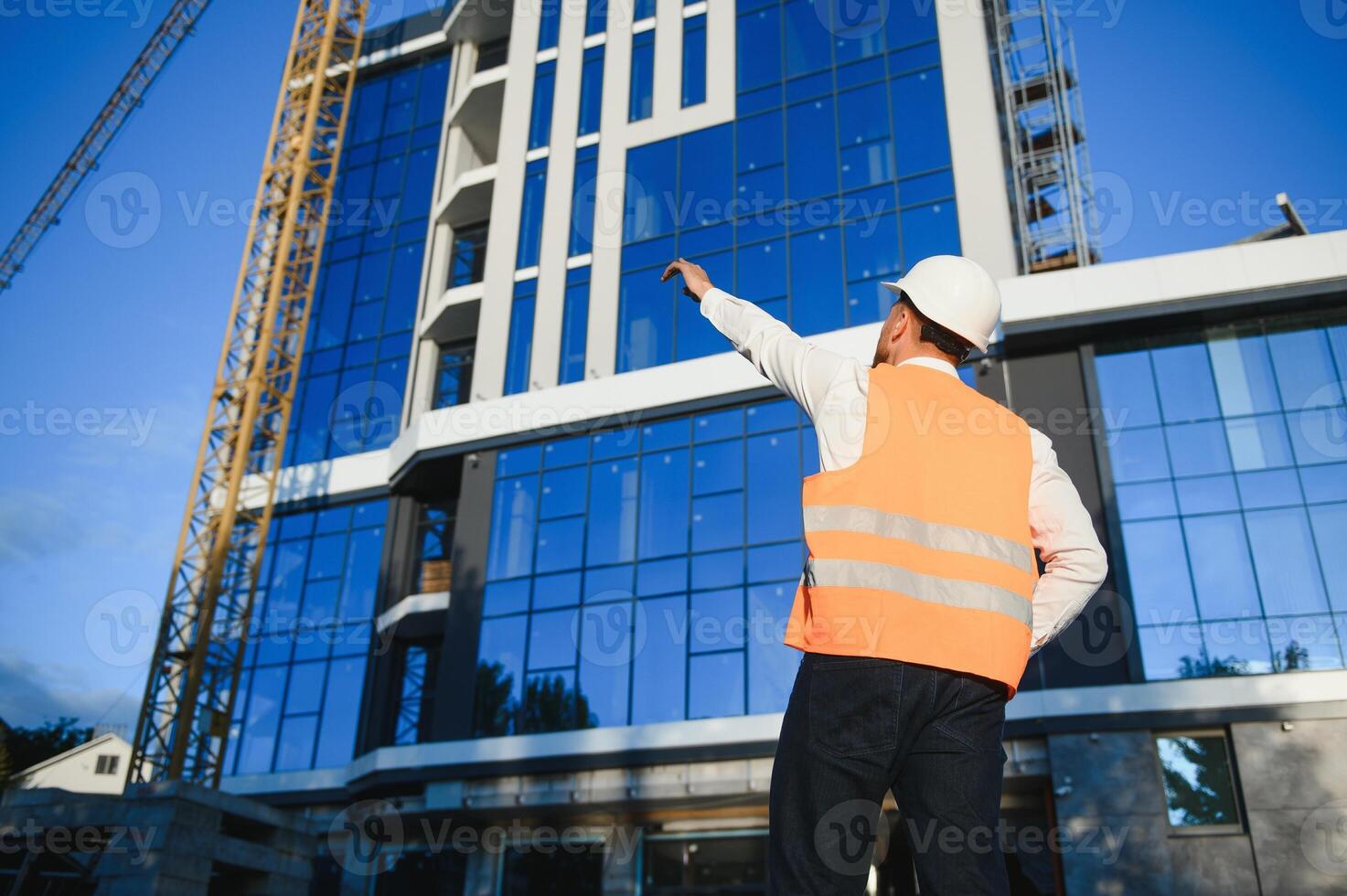 A construction worker control a pouring concrete pump on construction site and sunset background photo