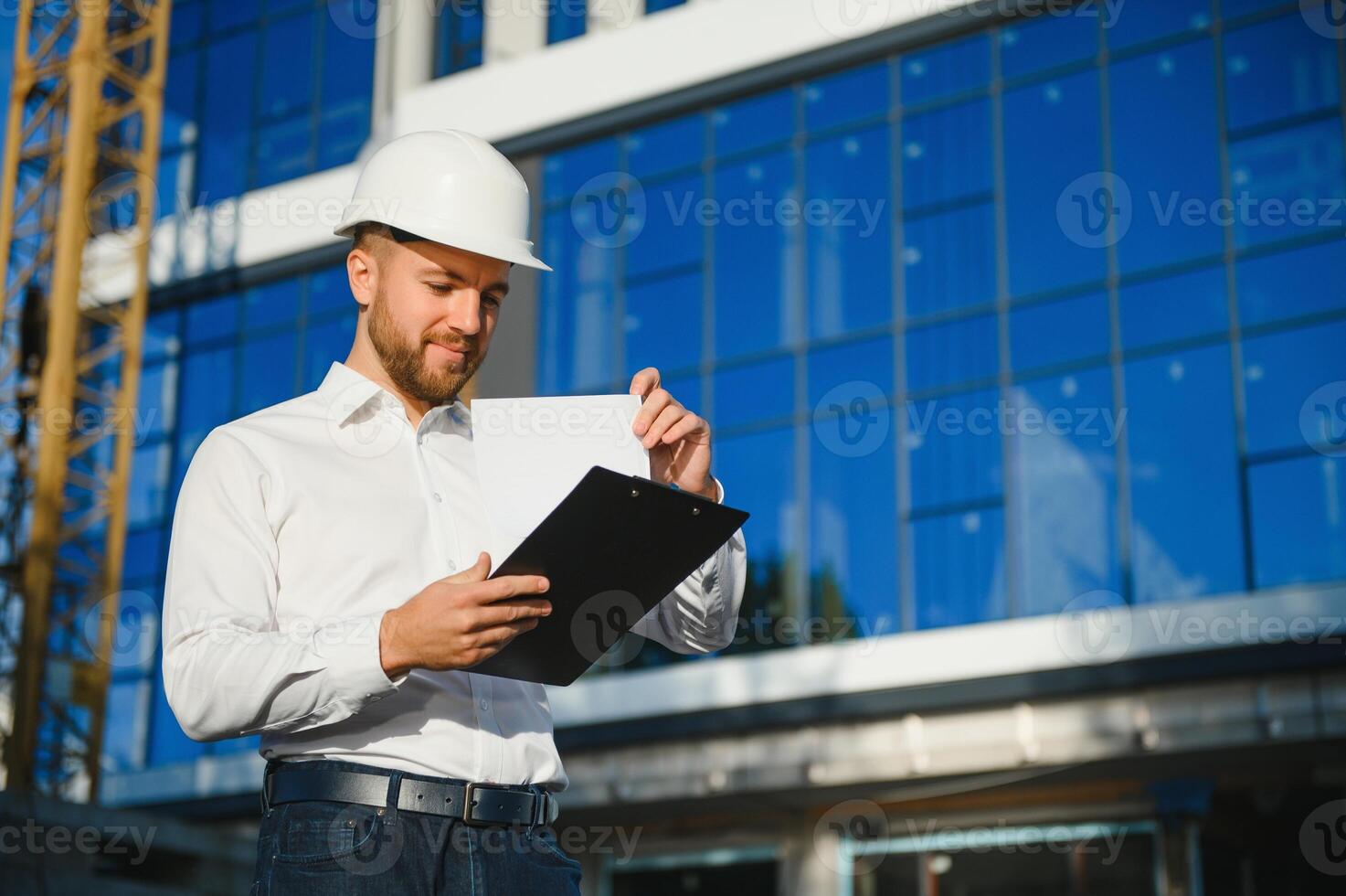 Portrait of building inspector with digital tablet on construction site photo
