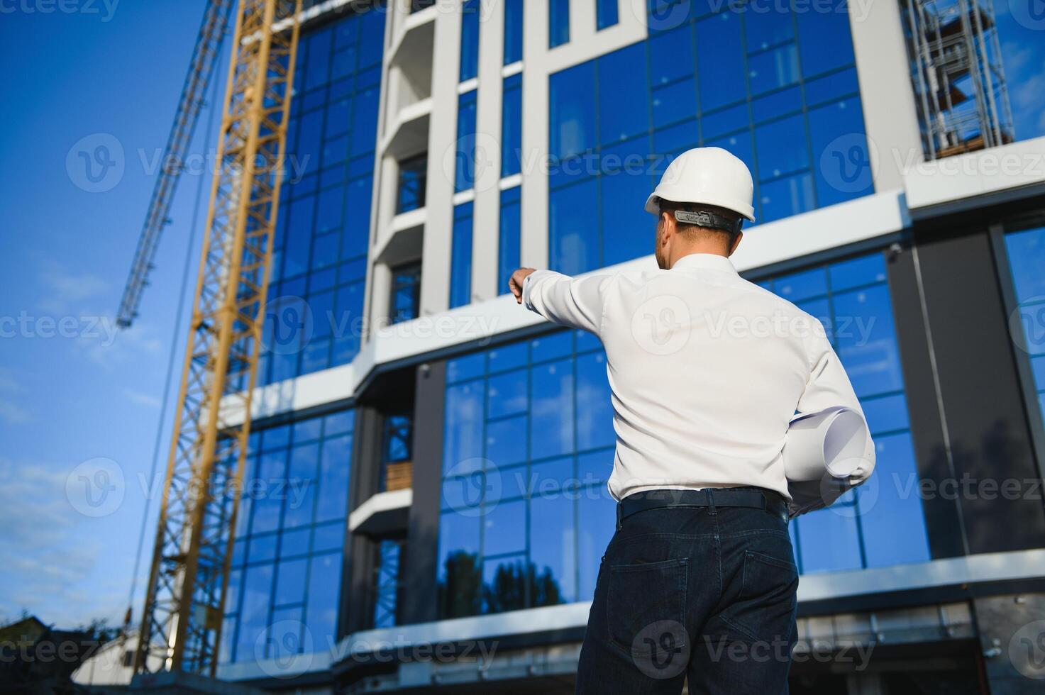 A construction worker control a pouring concrete pump on construction site and sunset background photo