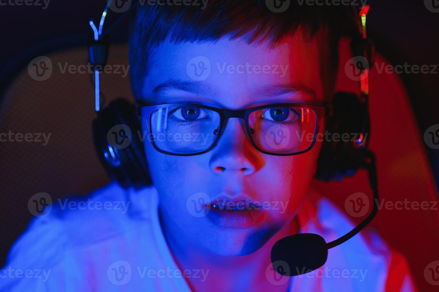 Boy in the headphones is playing a game. photo