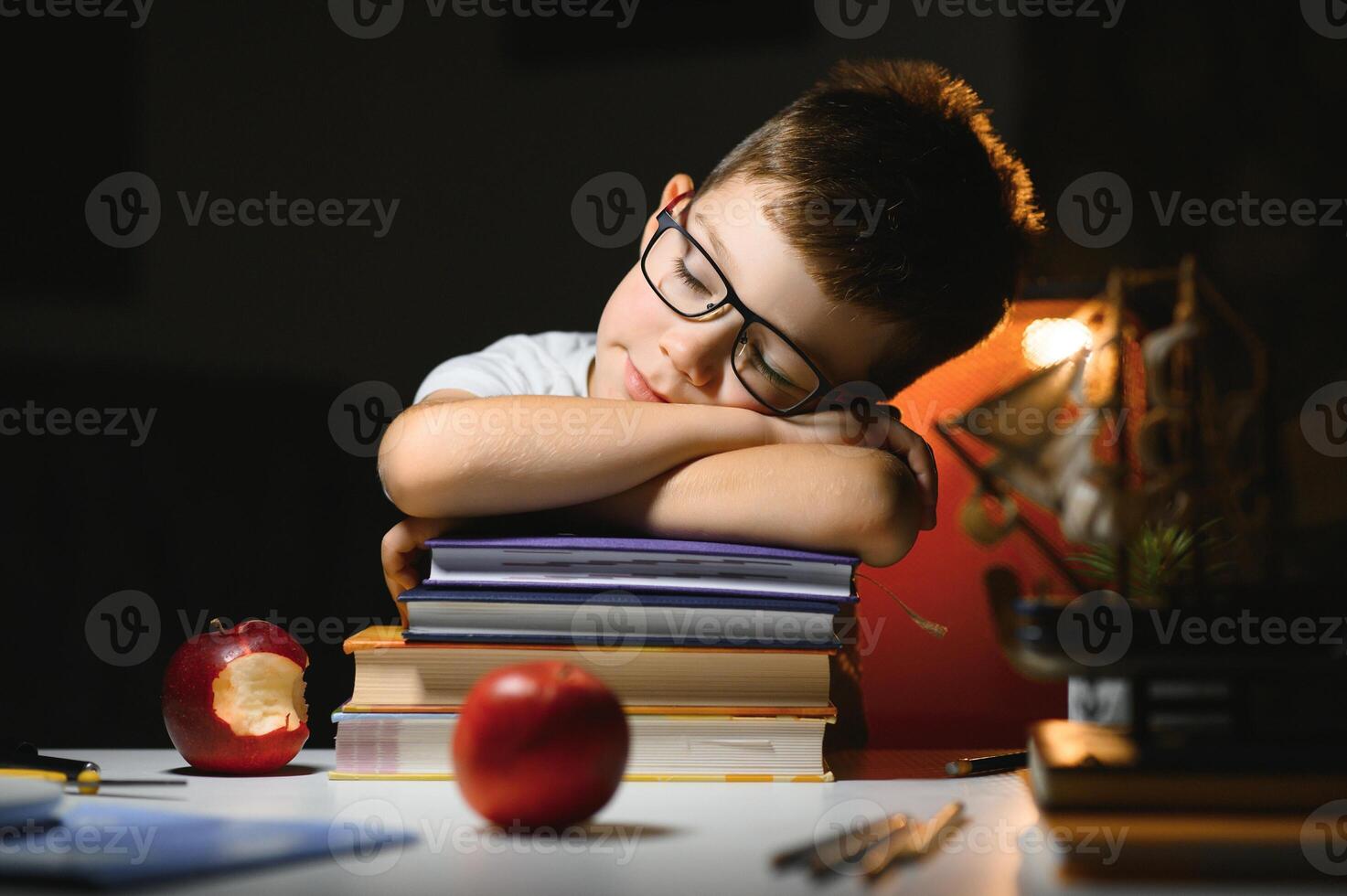 boy doing homework at home in evening photo