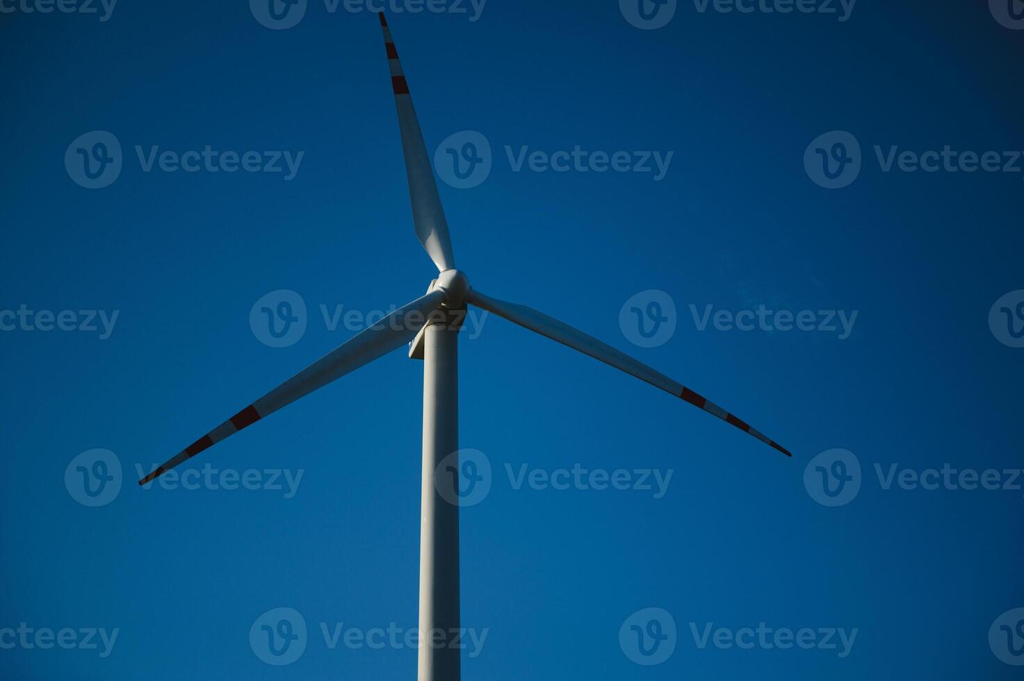Wind Turbines in a Green Field and Blue Sky. photo