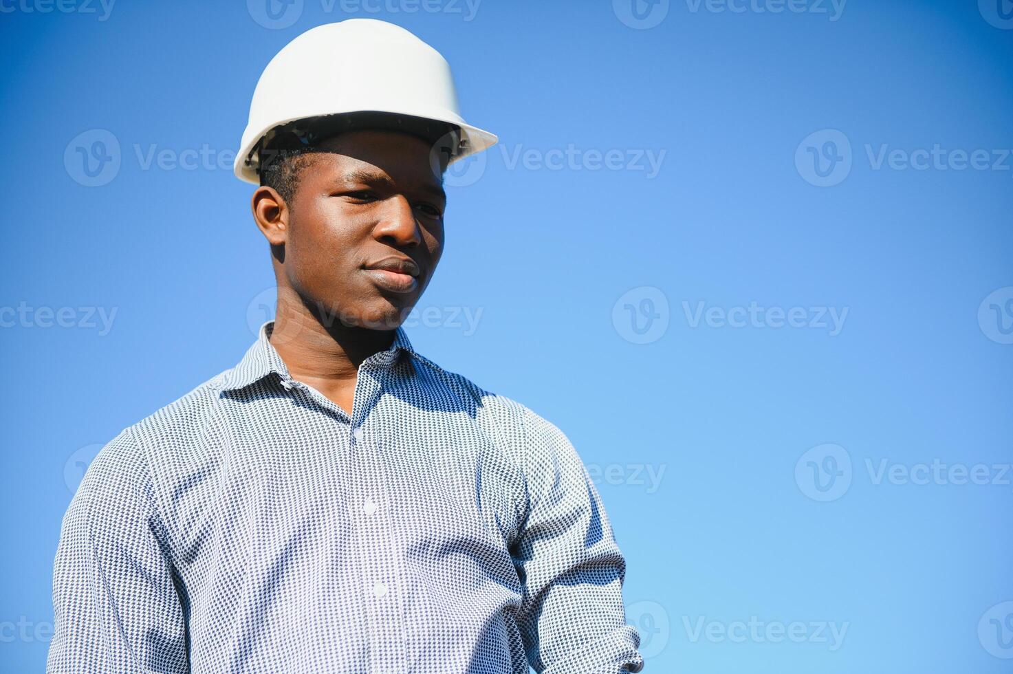 African American worker in a construction helmet photo