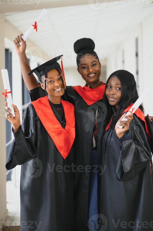 portrait of multiracial graduates holding diploma photo