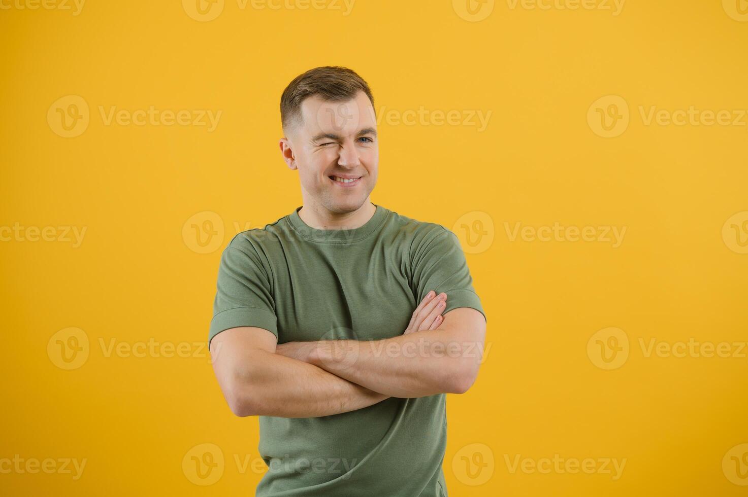 Young handsome man over blue background happy face smiling with crossed arms looking at the camera. Positive person. photo