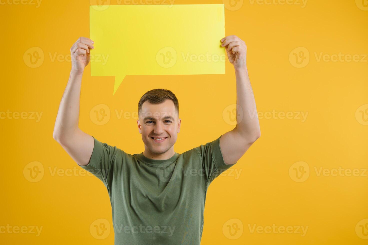 Young caucasian man isolated on yellow background holding a thinking speech bubble and doing OK sign photo
