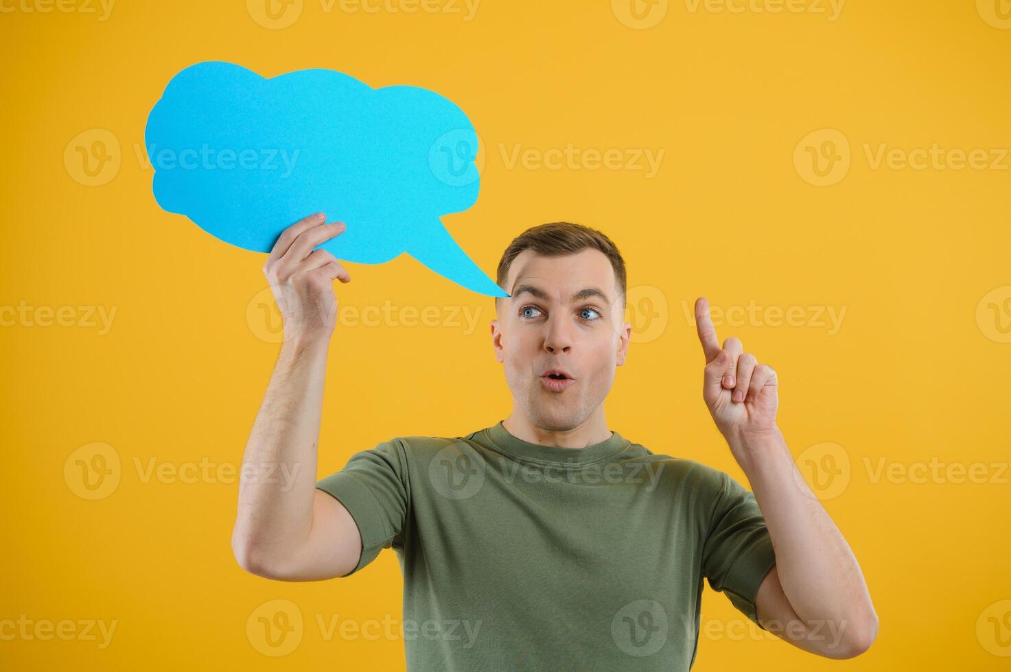 Young caucasian man isolated on yellow background holding a thinking speech bubble and doing OK sign photo