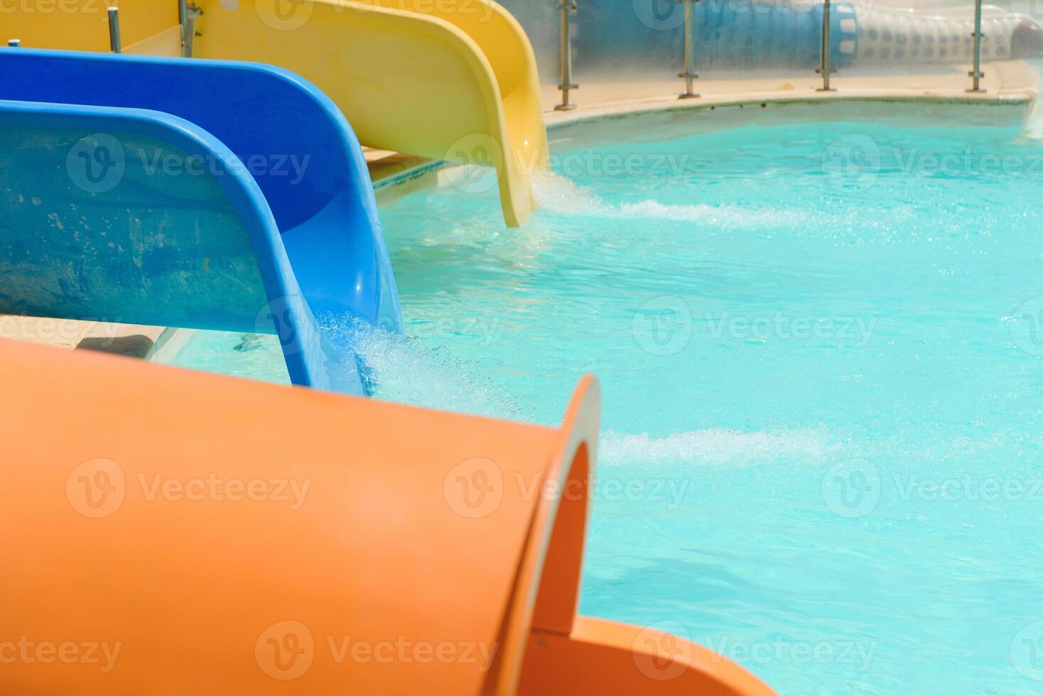 Colorful aquapark constructions in swimming-pool photo