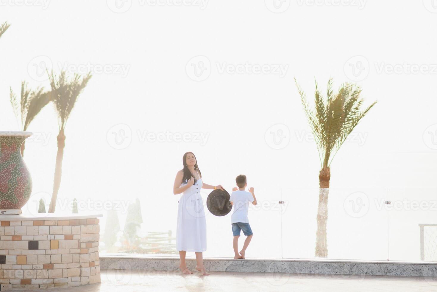 Happy family mother and son on the beach by the sea in summer photo