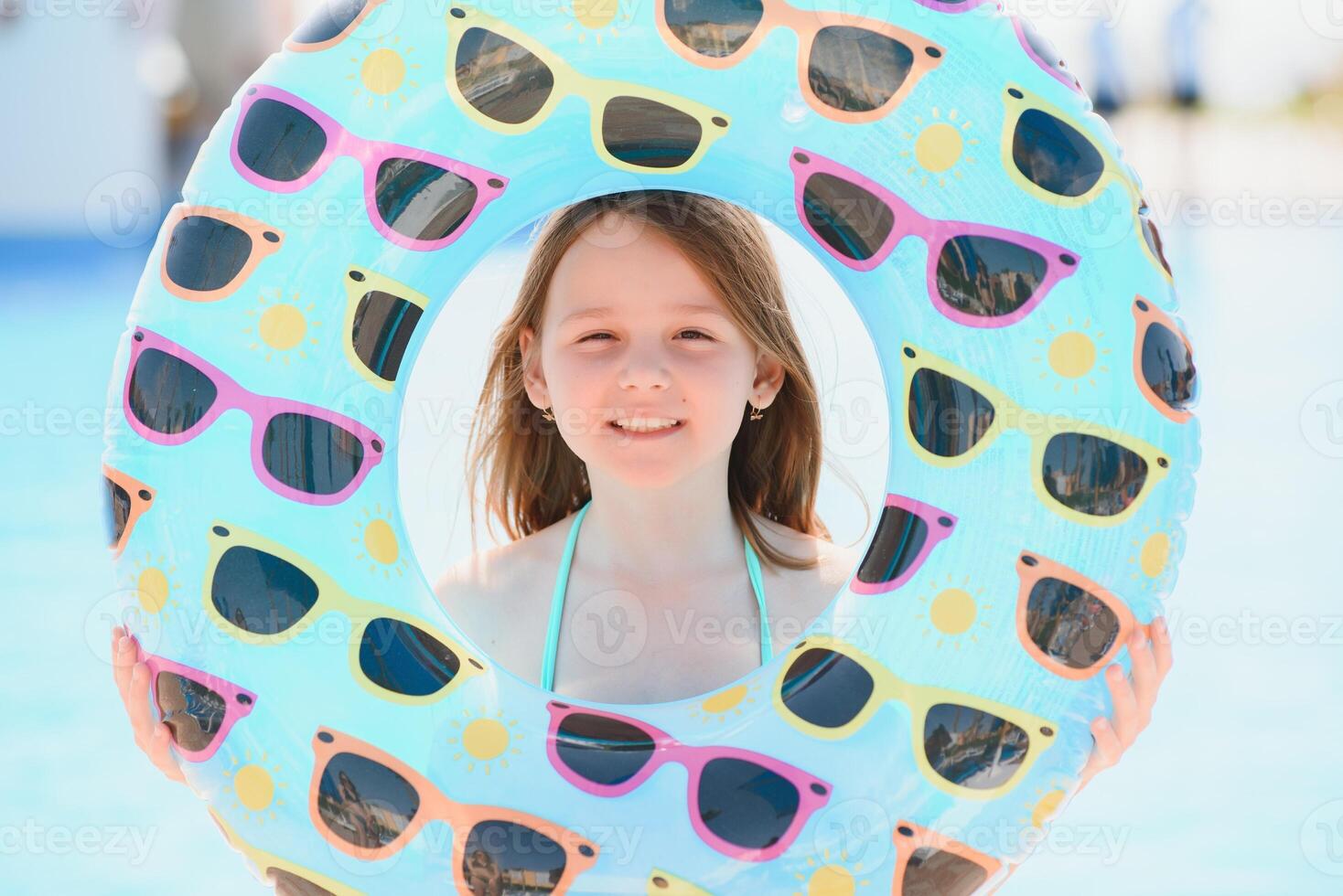 The concept of recreation at sea. The girl holds an inflatable circle for swimming by the pool photo