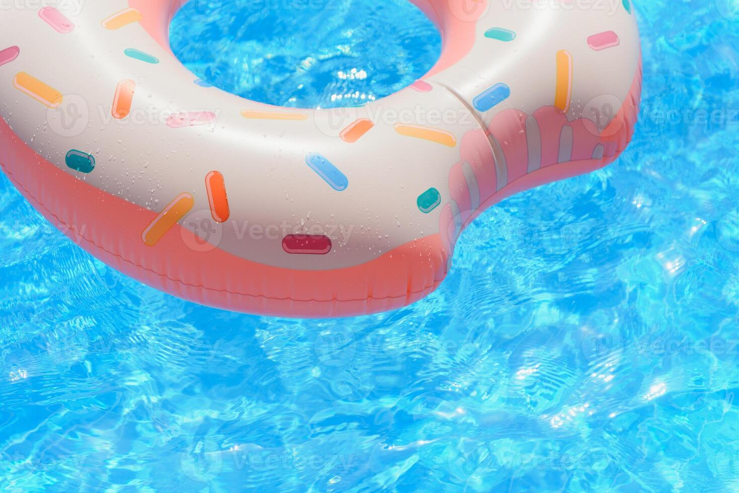 Pink inflatable donut swimming ring in a swimming pool photo