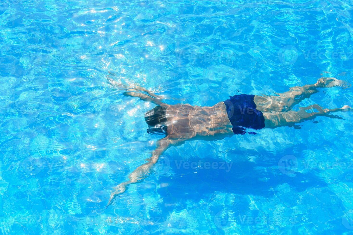 professional swimmer underwater after the jump photo