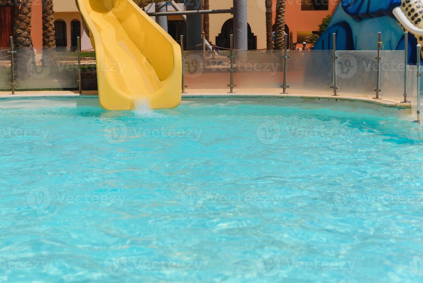 Colorful aquapark constructions in swimming-pool photo