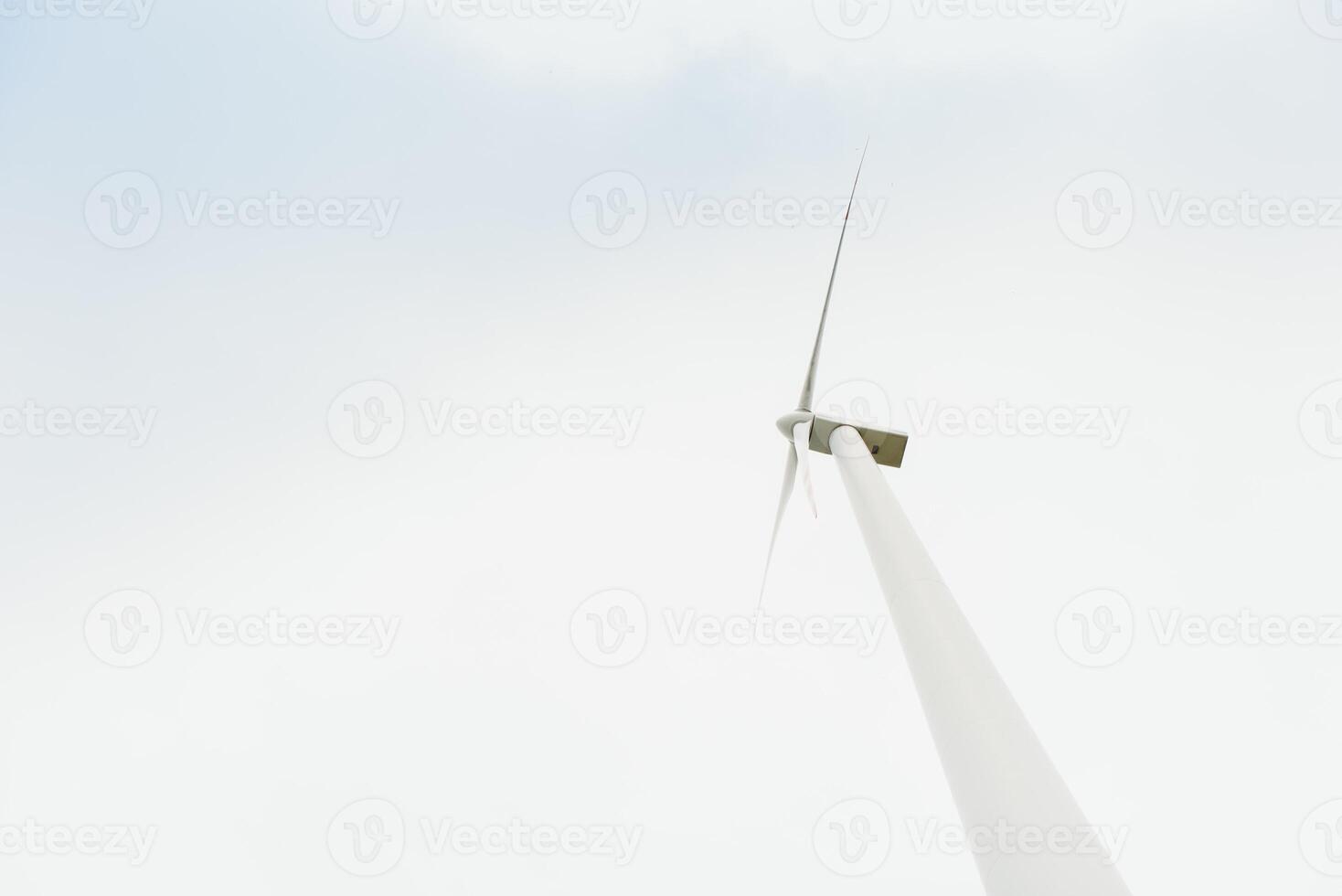 Windmill against cloudy sky with copyspace photo