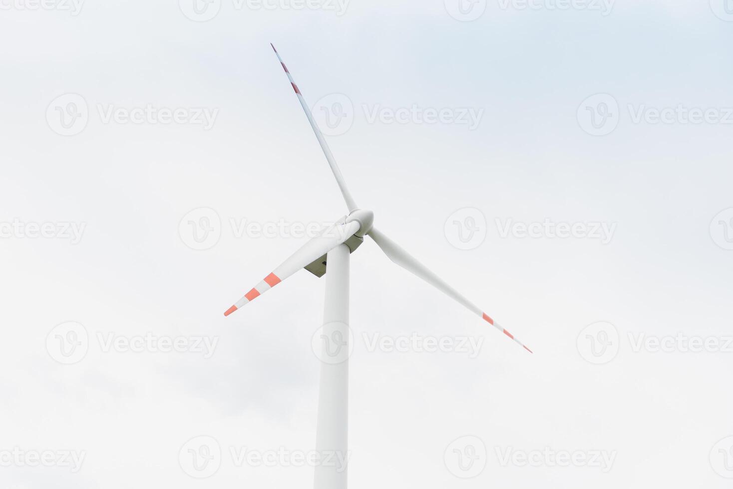Windmill against cloudy sky with copyspace photo