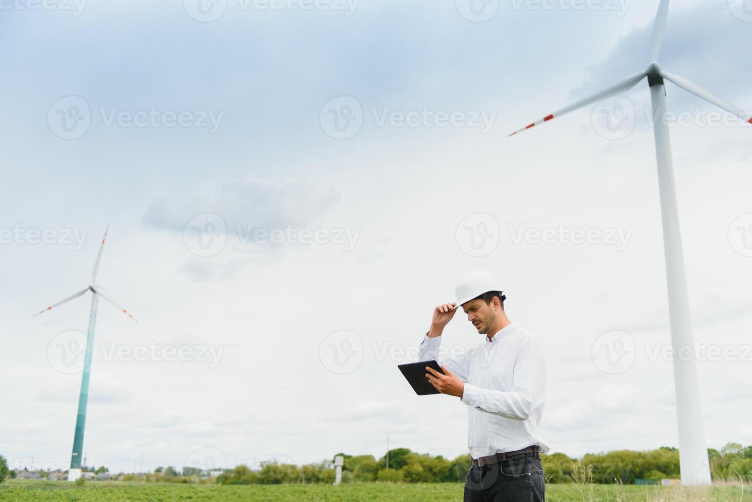 Engineer inspecting Project Manager at the Wind Farm. Man working in the enviromental photo