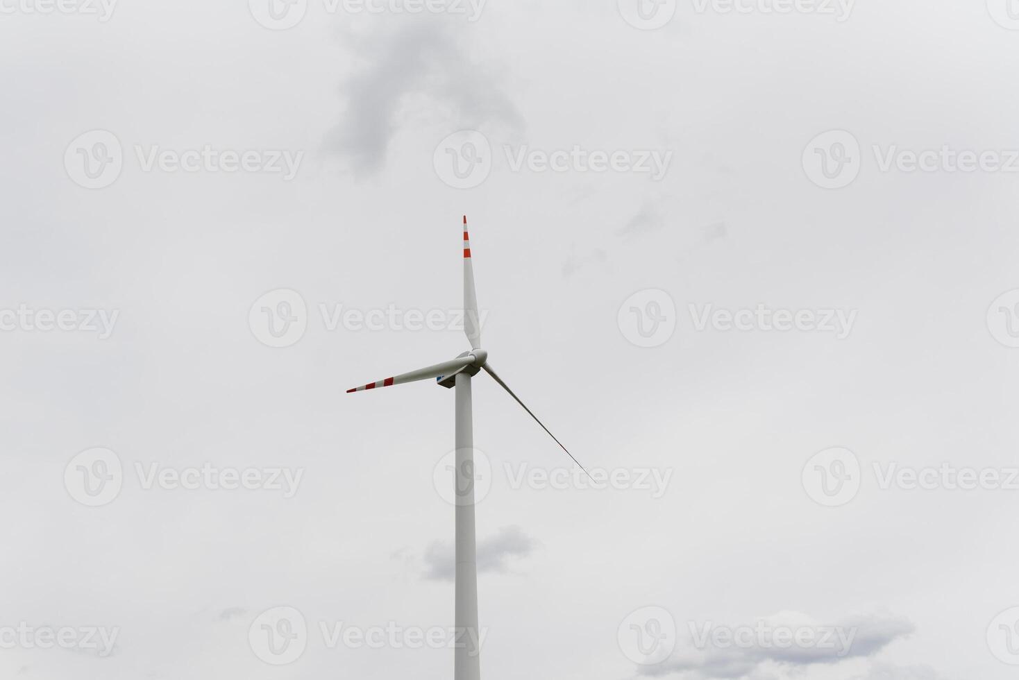 Windmill against cloudy sky with copyspace photo