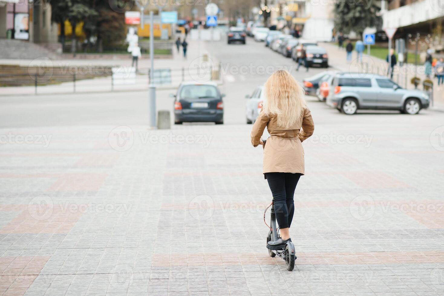 Portrait of a young woman with electro scooter photo