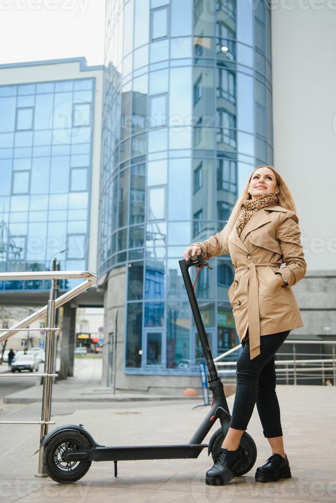 Young woman on electro scooter in city. photo