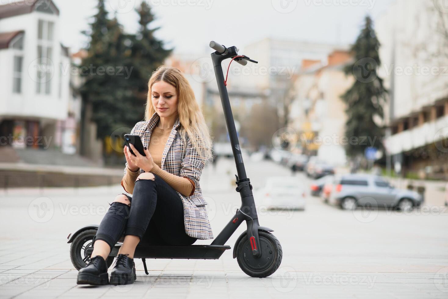 Young woman on electro scooter in city. photo