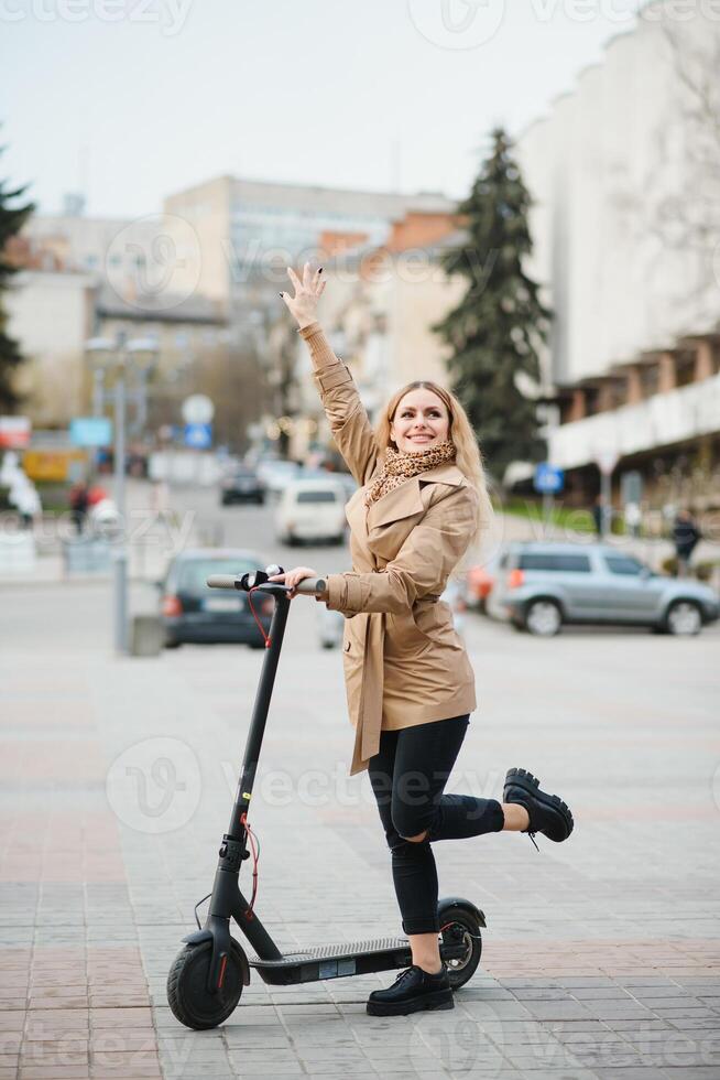 Girl in electric scooter riding in the old city center photo