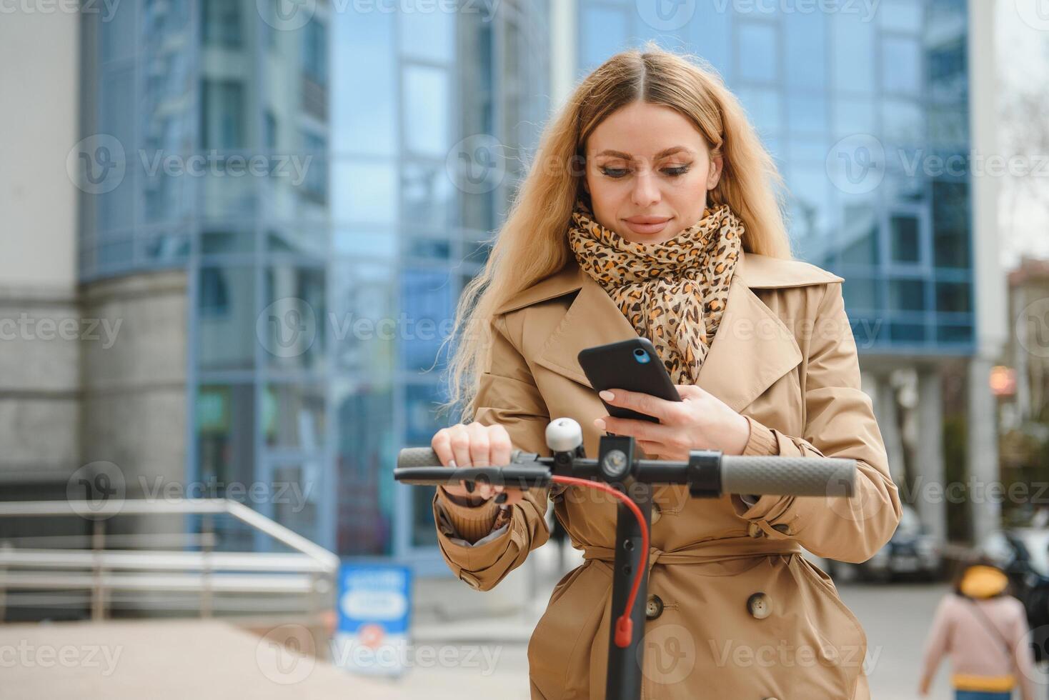 young woman on electro scooter in city. woman riding scooter in sunset light in street photo