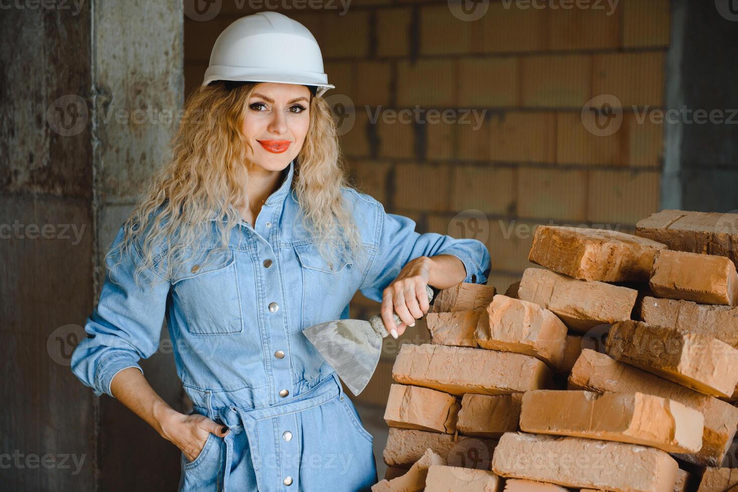 Warehouse woman worker. Woman builder in hardhat. Girl engineer or architect. Home renovation. Quality inspector. Construction job occupation. Construction worker. Lady at construction site photo