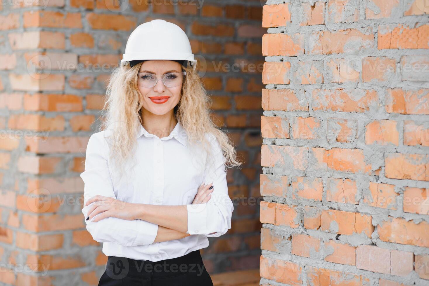 beatiful woman engineer is reviewing the plans of a construction work photo