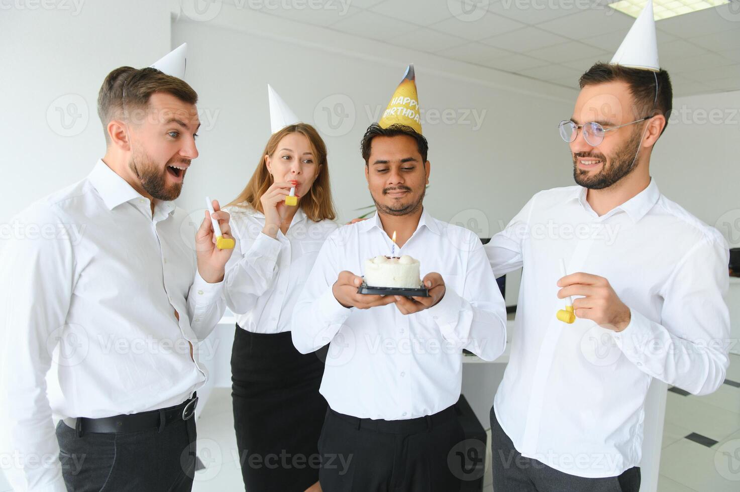 Surprise. Mixed race happy people celebrating a birthday of colleague in the modern office photo