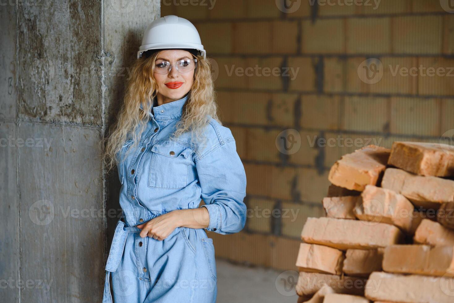 Warehouse woman worker. Woman builder in hardhat. Girl engineer or architect. Home renovation. Quality inspector. Construction job occupation. Construction worker. Lady at construction site. photo