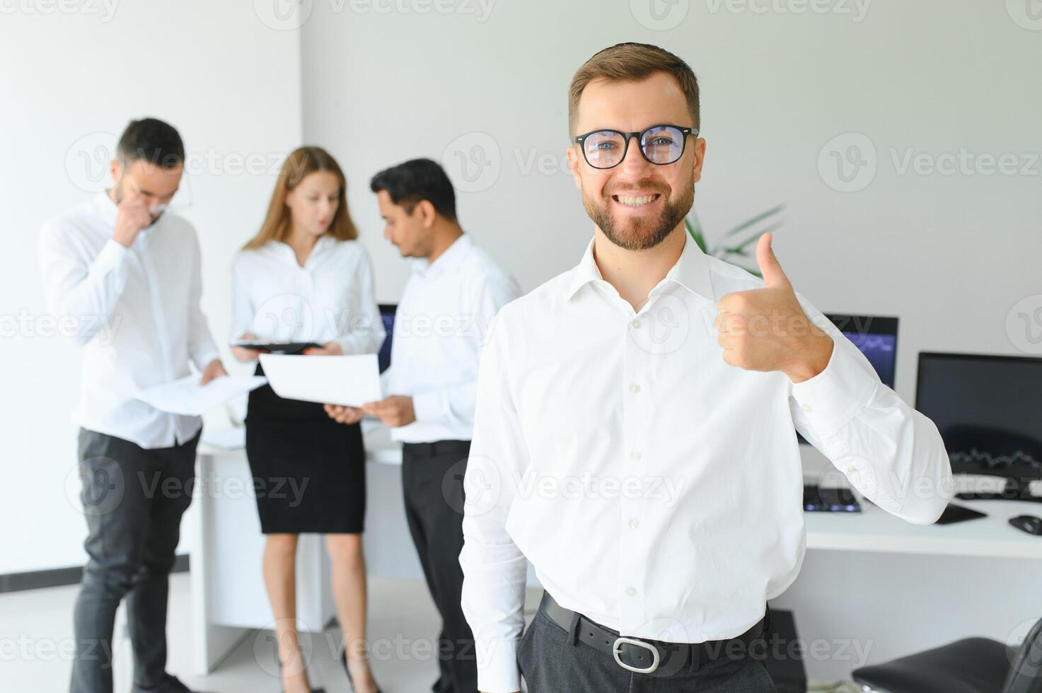 Business people stand on the background of the office corridor photo