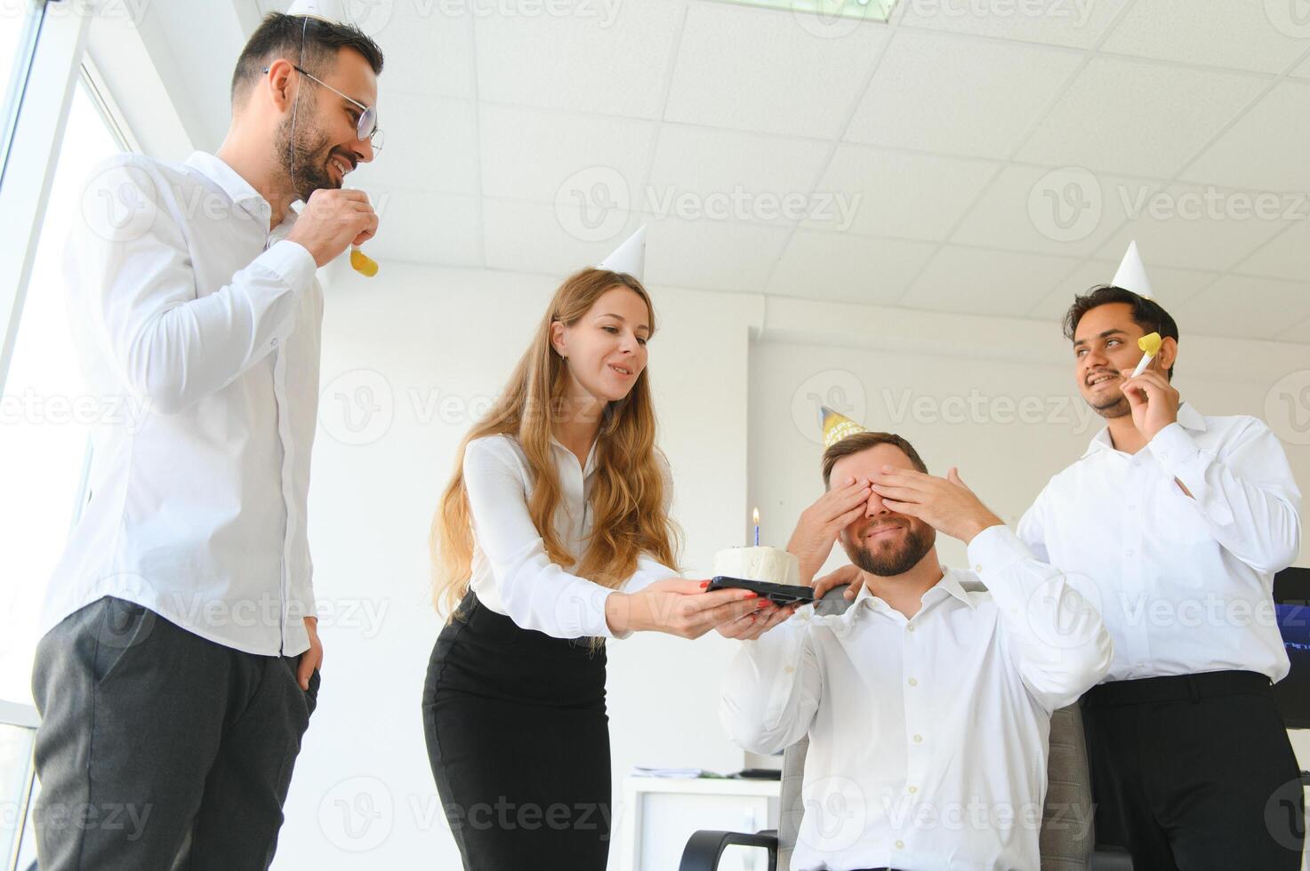 Business team celebrating a birthday of collegue in the modern office. photo