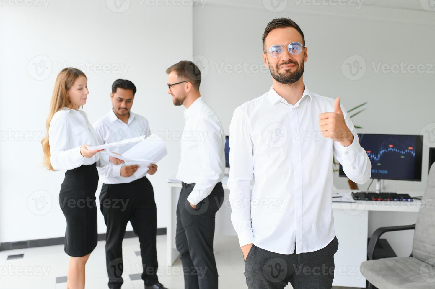 Business people stand on the background of the office corridor photo