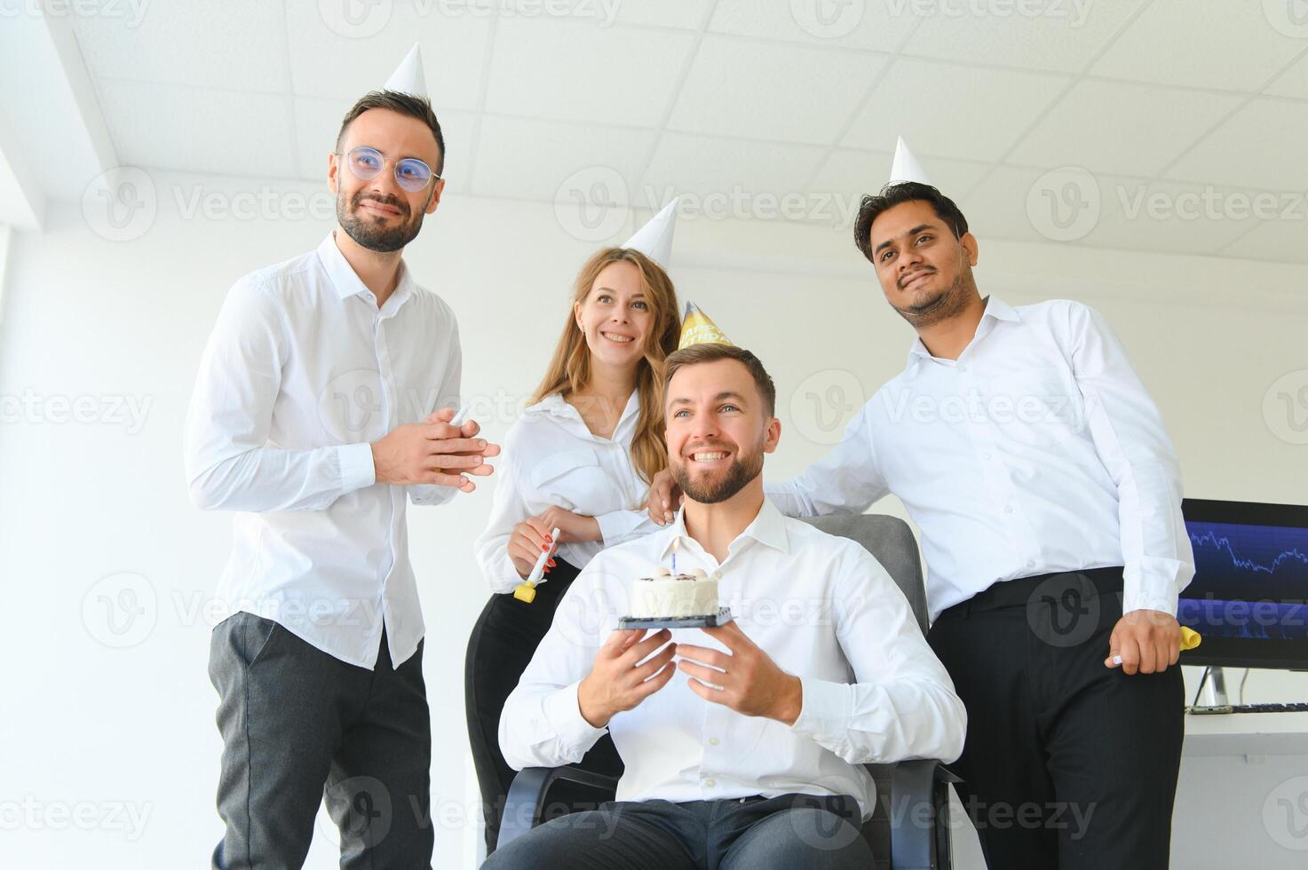 business team celebrating a birthday in the office. photo