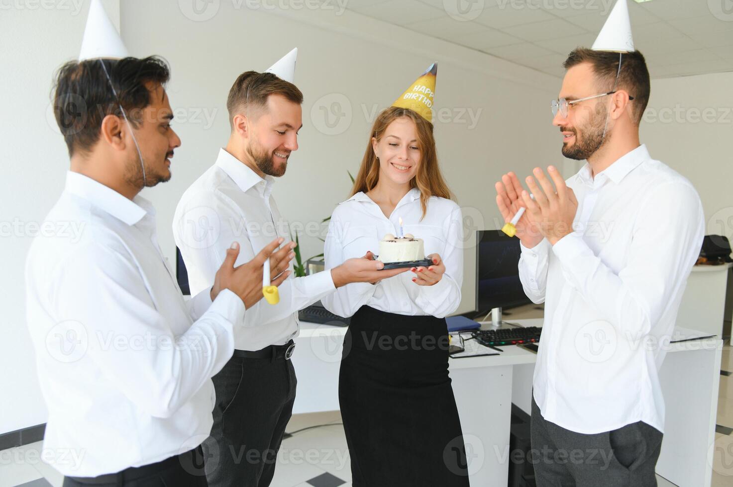 Business team celebrating a birthday of collegue in the modern office. photo