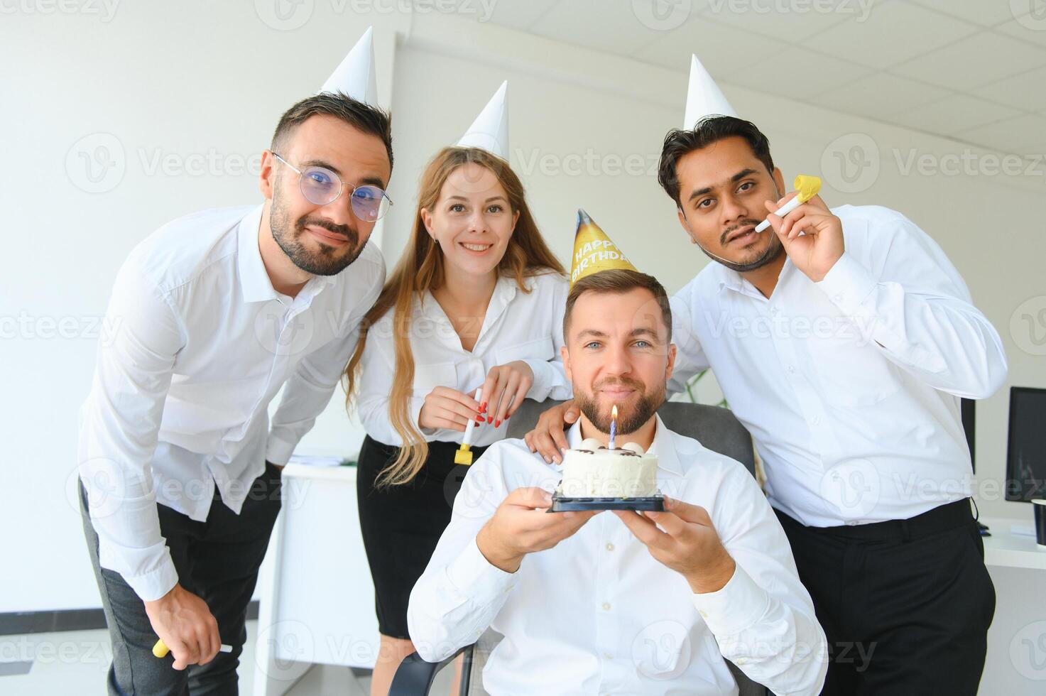 Business team celebrating a birthday of collegue in the modern office. photo
