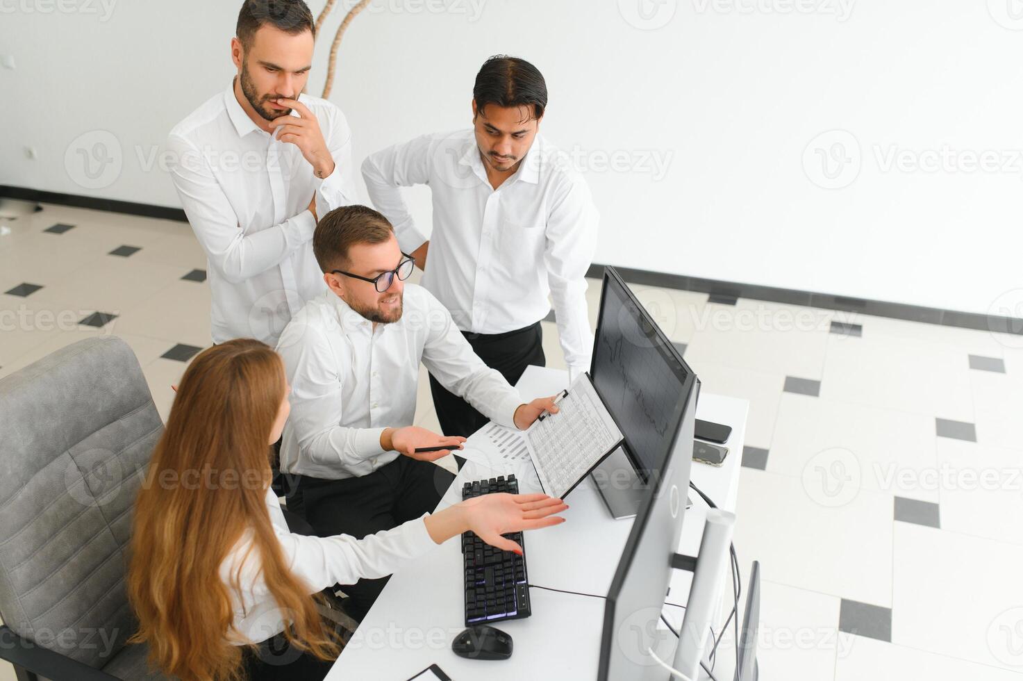 Happy businesspeople laughing while collaborating on a new project in an office. Group of diverse businesspeople working together in a modern workspace photo