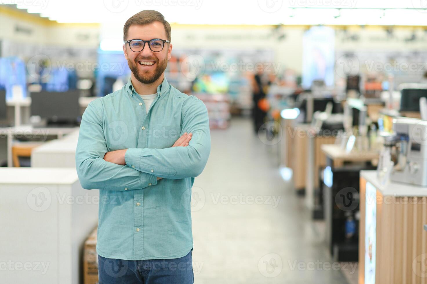 Happy man in electronics store. Big discounts photo