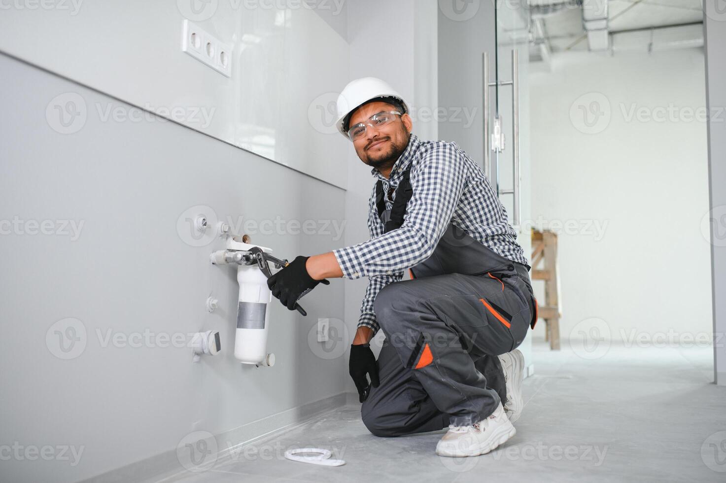 Indian Plumber installs or change water filter photo
