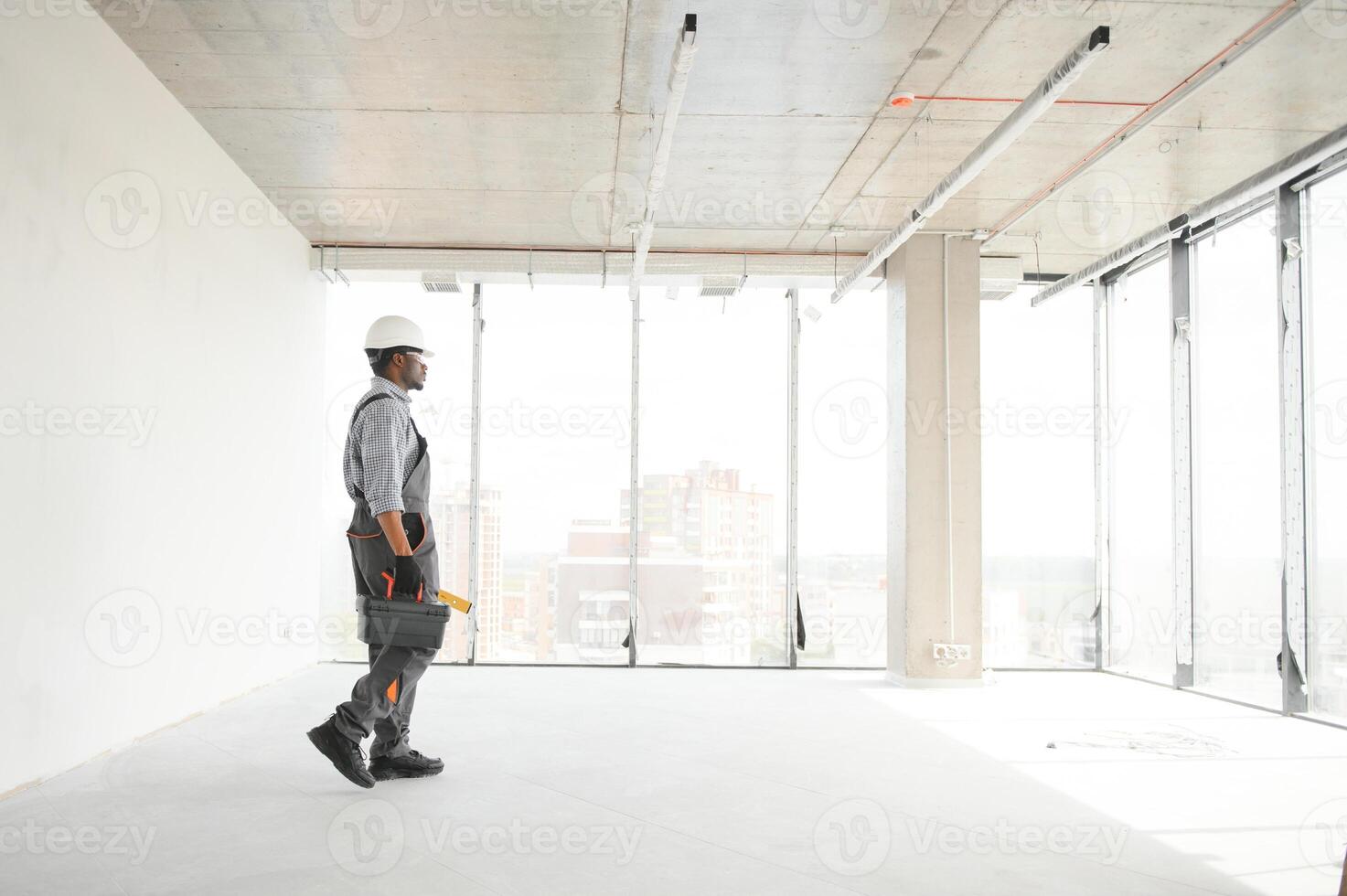 Construction worker in new house. Renovation background photo