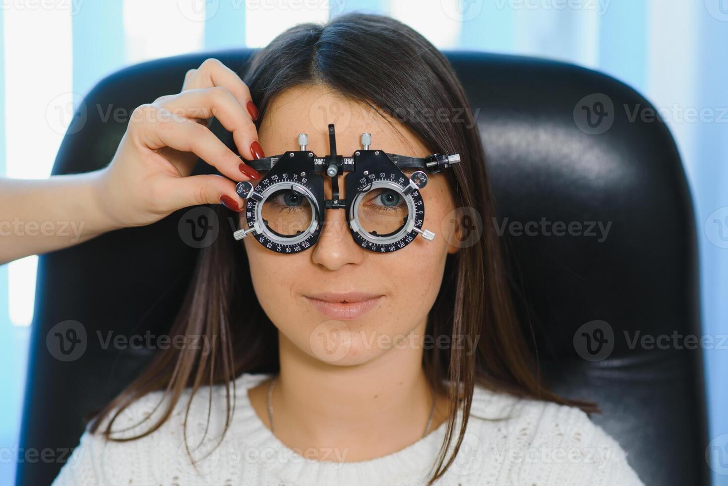 Selection of glasses for sight for the woman. The correct selection of points. Optical Salon. Optician. Trial lenses photo